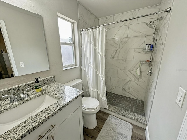7047 Hickory Branch Cir, Orlando, FL 32818 - full bathroom featuring vanity, a shower stall, and wood finished floors
