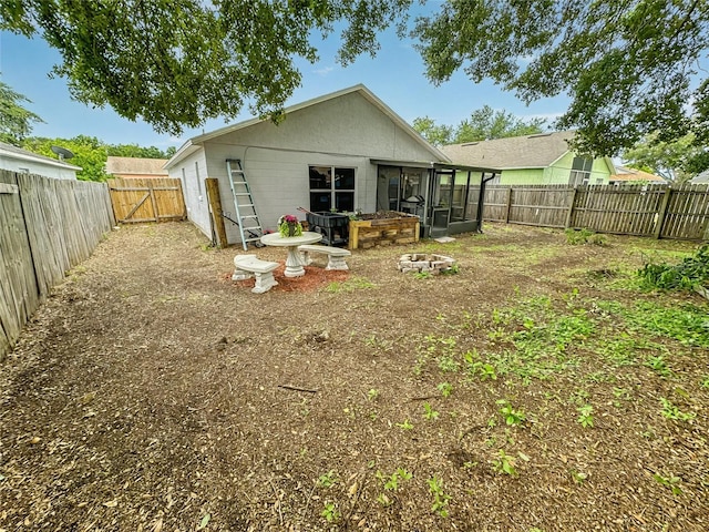 7047 Hickory Branch Cir, Orlando, FL 32818 - back of house featuring a sunroom, a fenced backyard, a gate, and concrete block siding