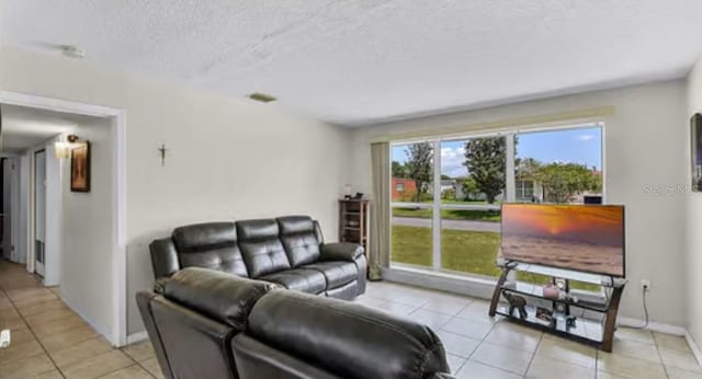 5912 Navajo Way, Orlando, FL 32807 - living area with light tile patterned floors and a textured ceiling
