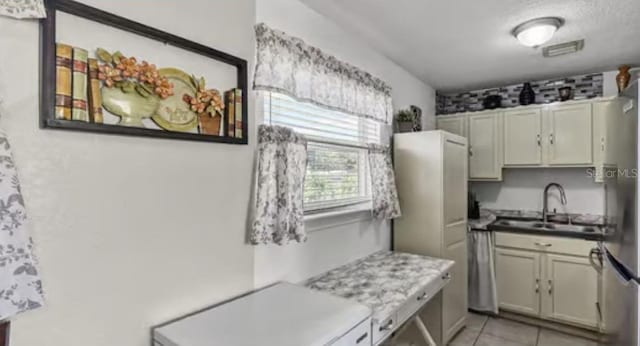 5912 Navajo Way, Orlando, FL 32807 - kitchen with freestanding refrigerator and light tile patterned floors