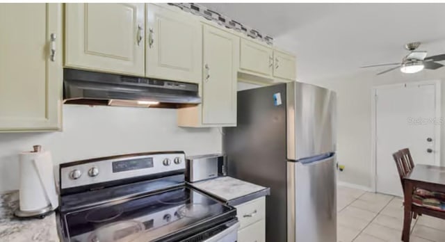 5912 Navajo Way, Orlando, FL 32807 - kitchen featuring appliances with stainless steel finishes, under cabinet range hood, ceiling fan, cream cabinets, and light tile patterned floors