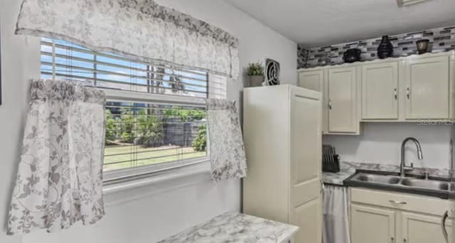 5912 Navajo Way, Orlando, FL 32807 - kitchen featuring freestanding refrigerator, plenty of natural light, and light countertops