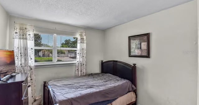 5912 Navajo Way, Orlando, FL 32807 - bedroom featuring a textured ceiling
