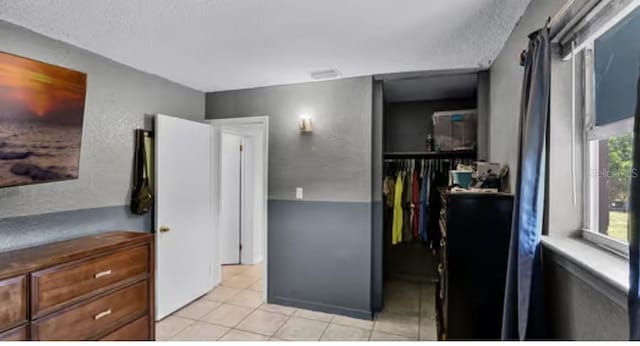 5912 Navajo Way, Orlando, FL 32807 - kitchen with light tile patterned floors and a textured ceiling