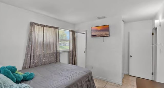 5912 Navajo Way, Orlando, FL 32807 - bedroom featuring light tile patterned floors and baseboards