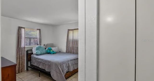5912 Navajo Way, Orlando, FL 32807 - bedroom with light tile patterned flooring