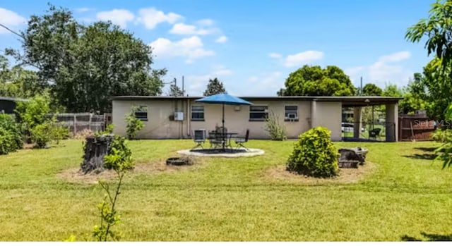 5912 Navajo Way, Orlando, FL 32807 - back of property with a yard and stucco siding