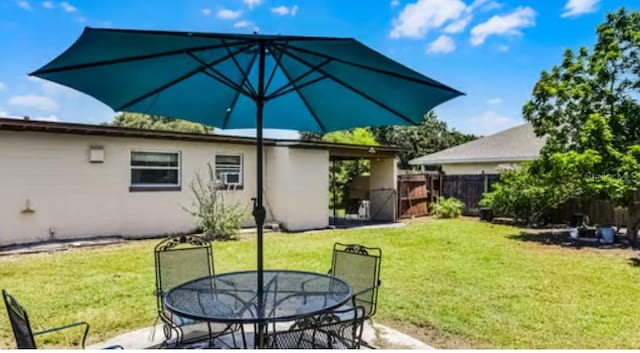 5912 Navajo Way, Orlando, FL 32807 - back of property featuring outdoor dining space and stucco siding