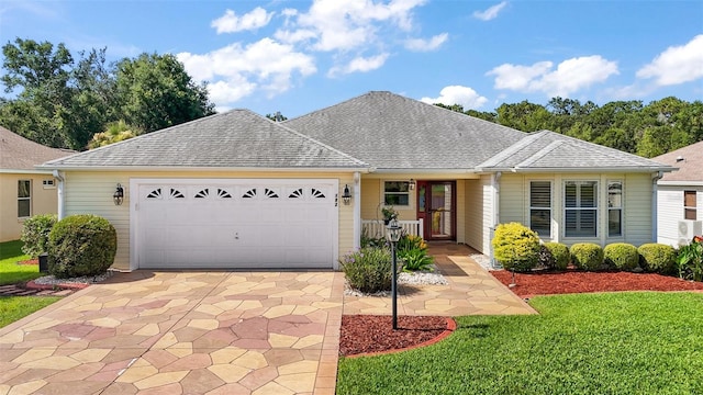 182 Palermo Pl, Lady Lake, FL 32159 - ranch-style home with driveway, a garage, a front lawn, and roof with shingles