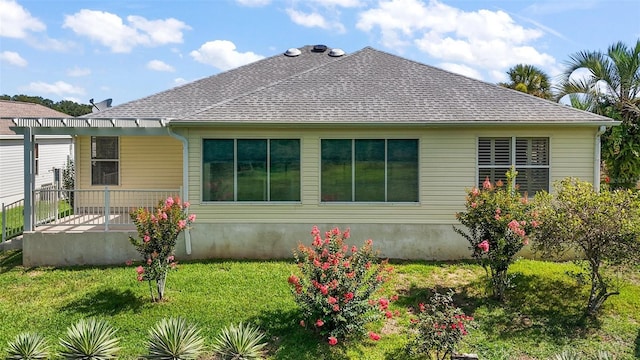 182 Palermo Pl, Lady Lake, FL 32159 - back of house featuring a pergola, a lawn, and roof with shingles