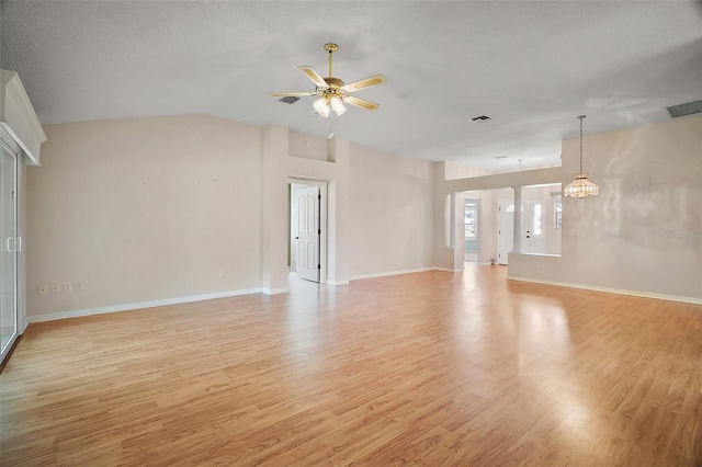 182 Palermo Pl, Lady Lake, FL 32159 - unfurnished living room with light wood-style floors, ceiling fan, a chandelier, and vaulted ceiling