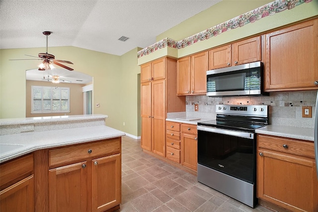 182 Palermo Pl, Lady Lake, FL 32159 - kitchen featuring stainless steel appliances, ceiling fan, vaulted ceiling, light countertops, and tasteful backsplash