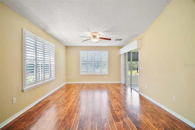 182 Palermo Pl, Lady Lake, FL 32159 - unfurnished room with ceiling fan, a textured ceiling, and wood finished floors