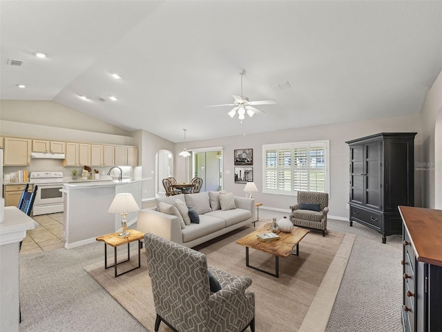 11092 SE 174th Loop, Summerfield, FL 34491 - living room featuring arched walkways, lofted ceiling, light carpet, and ceiling fan