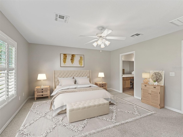 11092 SE 174th Loop, Summerfield, FL 34491 - bedroom with light colored carpet, a ceiling fan, and ensuite bath