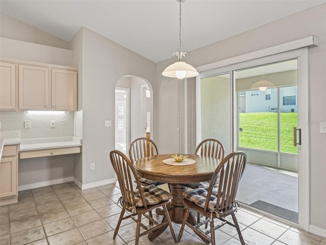 11092 SE 174th Loop, Summerfield, FL 34491 - dining space featuring lofted ceiling, arched walkways, light tile patterned floors, and built in desk