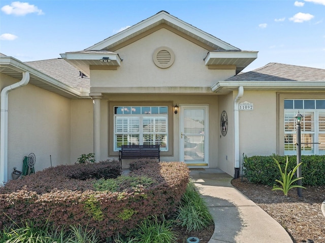 11092 SE 174th Loop, Summerfield, FL 34491 - property entrance featuring stucco siding and a shingled roof