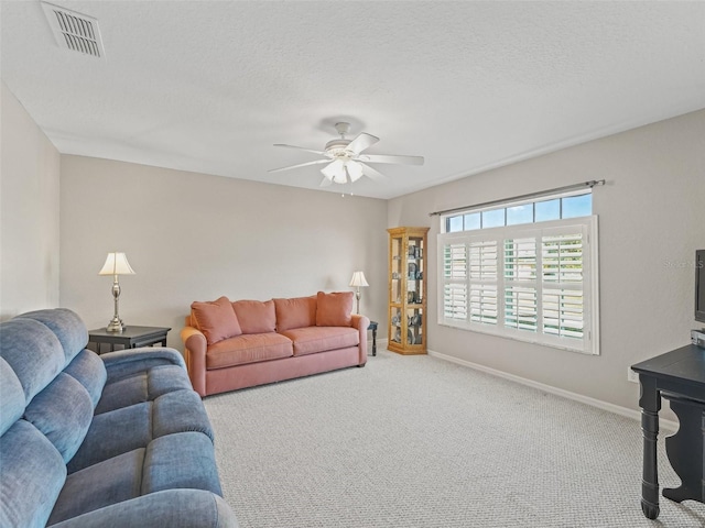 11092 SE 174th Loop, Summerfield, FL 34491 - living room featuring a ceiling fan, carpet floors, and a textured ceiling
