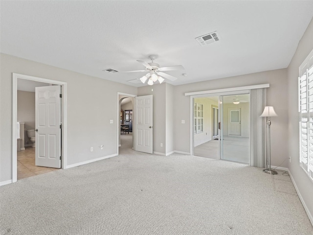 11092 SE 174th Loop, Summerfield, FL 34491 - unfurnished bedroom featuring light carpet, ceiling fan, arched walkways, and access to exterior