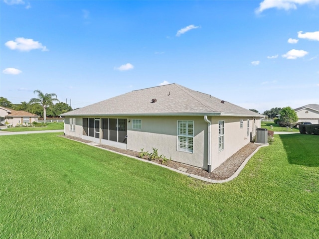 11092 SE 174th Loop, Summerfield, FL 34491 - back of house with stucco siding, a yard, and a shingled roof