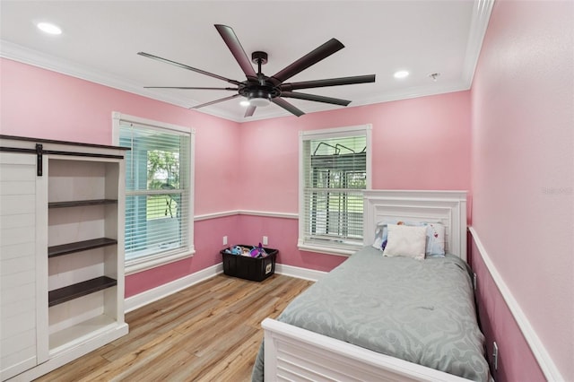 40535 Louise Rd, Umatilla, FL 32784 - bedroom with wood finished floors, ornamental molding, a barn door, recessed lighting, and ceiling fan