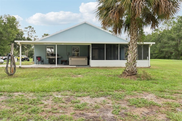 40535 Louise Rd, Umatilla, FL 32784 - rear view of house with a sunroom, a yard, and a patio
