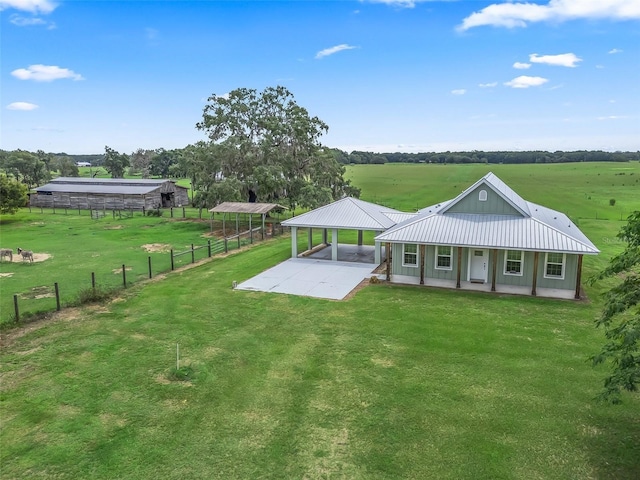 8567 Crk 635, Bushnell, FL 33513 - rear view of house with a carport, a metal roof, a view of rural / pastoral area, and covered porch