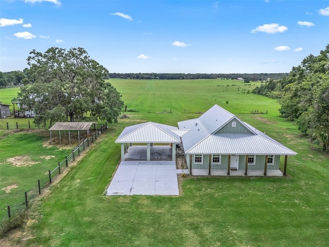 8567 Crk 635, Bushnell, FL 33513 - back of property with a detached carport, a lawn, concrete driveway, a metal roof, and a rural view