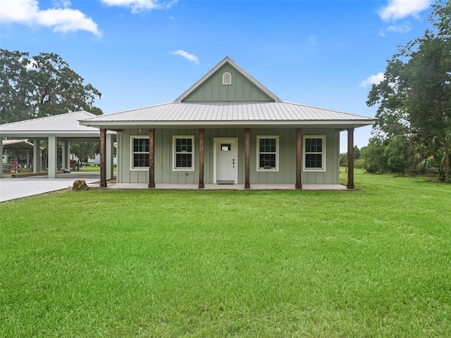 8567 Crk 635, Bushnell, FL 33513 - farmhouse featuring board and batten siding, a front lawn, a porch, an attached carport, and concrete driveway