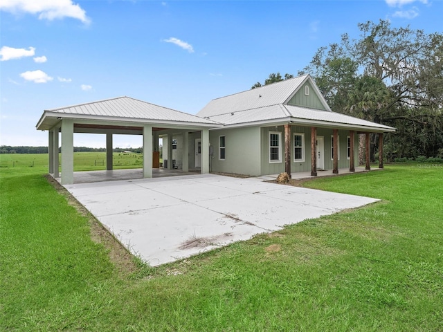 8567 Crk 635, Bushnell, FL 33513 - back of property with driveway, a lawn, and a metal roof