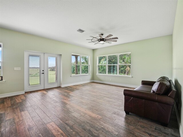 8567 Crk 635, Bushnell, FL 33513 - sitting room with dark wood finished floors, ceiling fan, and french doors