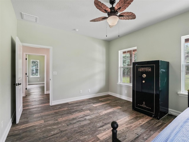 8567 Crk 635, Bushnell, FL 33513 - unfurnished bedroom featuring multiple windows, wood finished floors, and ceiling fan