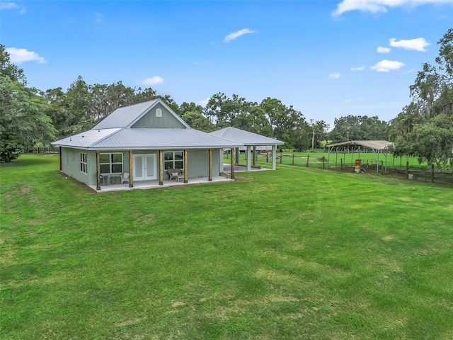 8567 Crk 635, Bushnell, FL 33513 - rear view of house featuring french doors, a patio, view of wooded area, and a metal roof