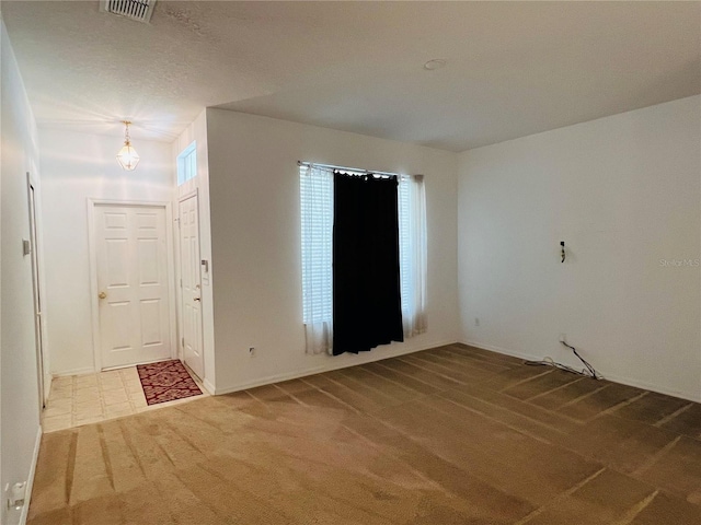 unfurnished room featuring carpet and baseboards