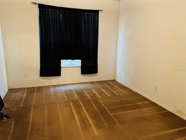 empty room with carpet flooring and baseboards