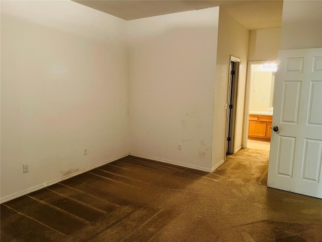 spare room with carpet flooring and baseboards