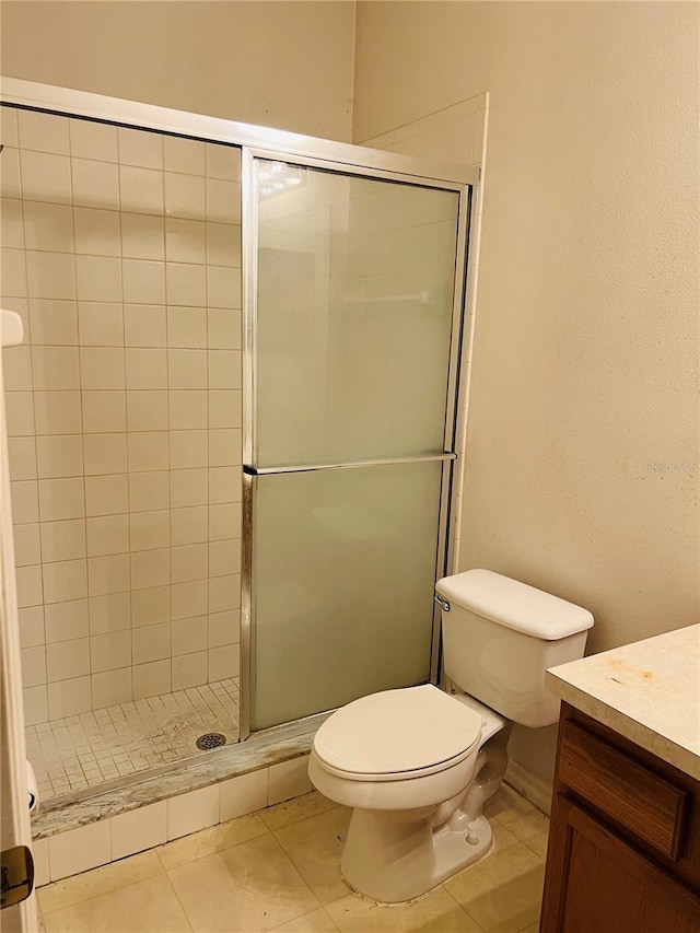 full bathroom featuring vanity, a stall shower, and tile patterned floors