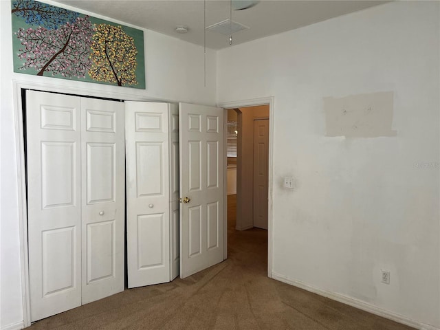 unfurnished bedroom featuring carpet flooring and a closet