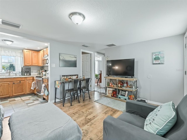 709 S Dixie Ave, Fruitland Park, FL 34731 - living room with light wood-style flooring and a textured ceiling