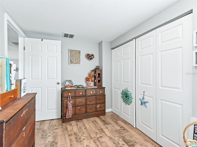 709 S Dixie Ave, Fruitland Park, FL 34731 - bedroom with light wood-style floors and a closet