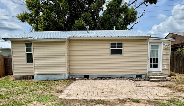 709 S Dixie Ave, Fruitland Park, FL 34731 - view of home's exterior with crawl space, a metal roof, a patio, and entry steps
