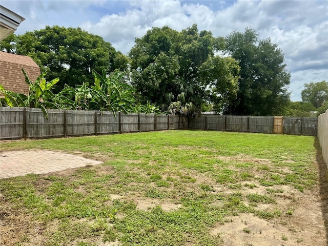 709 S Dixie Ave, Fruitland Park, FL 34731 - fenced backyard featuring a patio