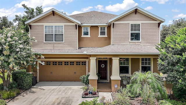 30230 Tokara Ter, Mount Dora, FL 32757 - view of front of house featuring a porch, driveway, a shingled roof, a garage, and stucco siding