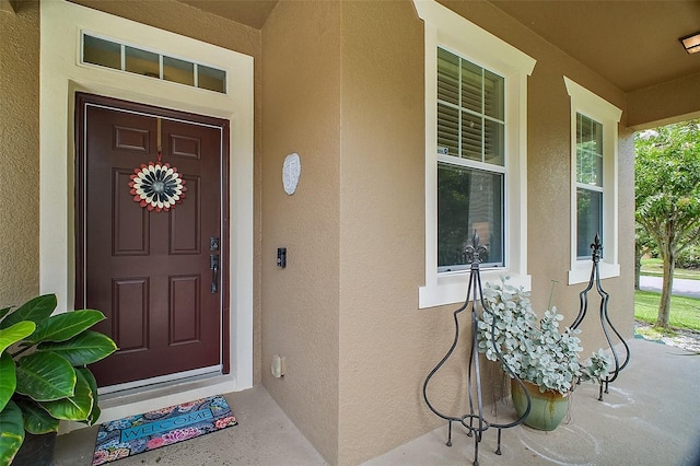 30230 Tokara Ter, Mount Dora, FL 32757 - doorway to property featuring covered porch and stucco siding
