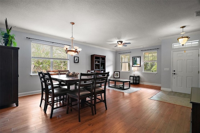 30230 Tokara Ter, Mount Dora, FL 32757 - dining area with ceiling fan, wood finished floors, ornamental molding, a textured ceiling, and a chandelier