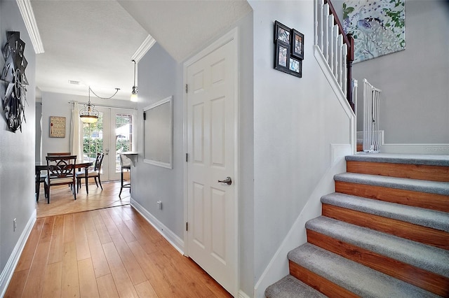 30230 Tokara Ter, Mount Dora, FL 32757 - stairs featuring hardwood / wood-style floors and a chandelier