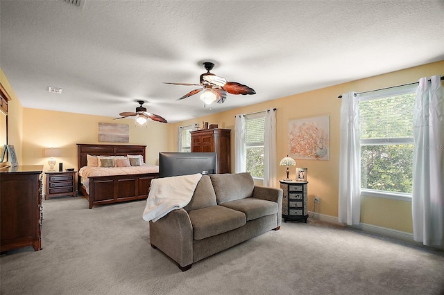 30230 Tokara Ter, Mount Dora, FL 32757 - bedroom with light colored carpet, a ceiling fan, and a textured ceiling