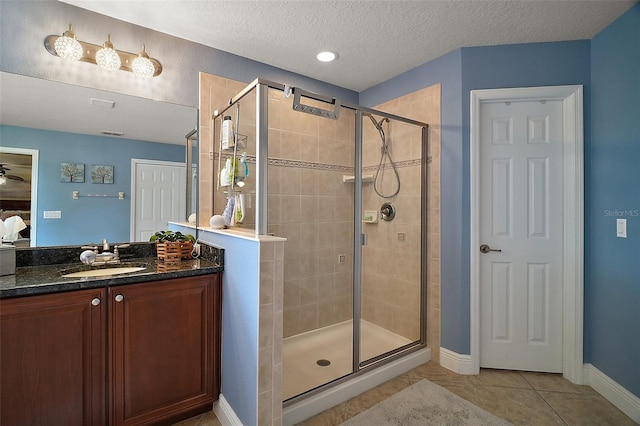 30230 Tokara Ter, Mount Dora, FL 32757 - bathroom featuring a shower stall, vanity, tile patterned floors, and a textured ceiling