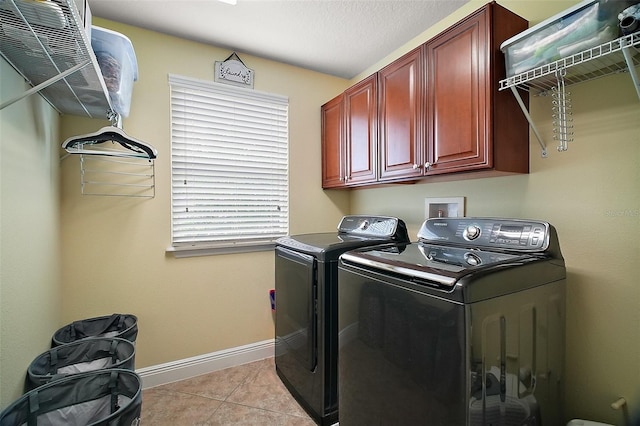 30230 Tokara Ter, Mount Dora, FL 32757 - laundry area featuring washing machine and clothes dryer, cabinet space, and light tile patterned flooring