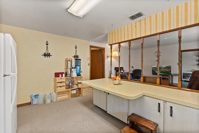 5268 Pinto Way, Orlando, FL 32810 - kitchen featuring freestanding refrigerator, light carpet, and light countertops